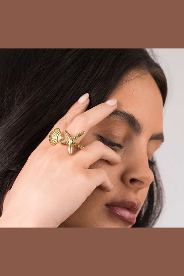 Close-up of a woman wearing the ARIIRA Mira Starfish and Shell Pearl Ring, showcasing its ocean-inspired design.