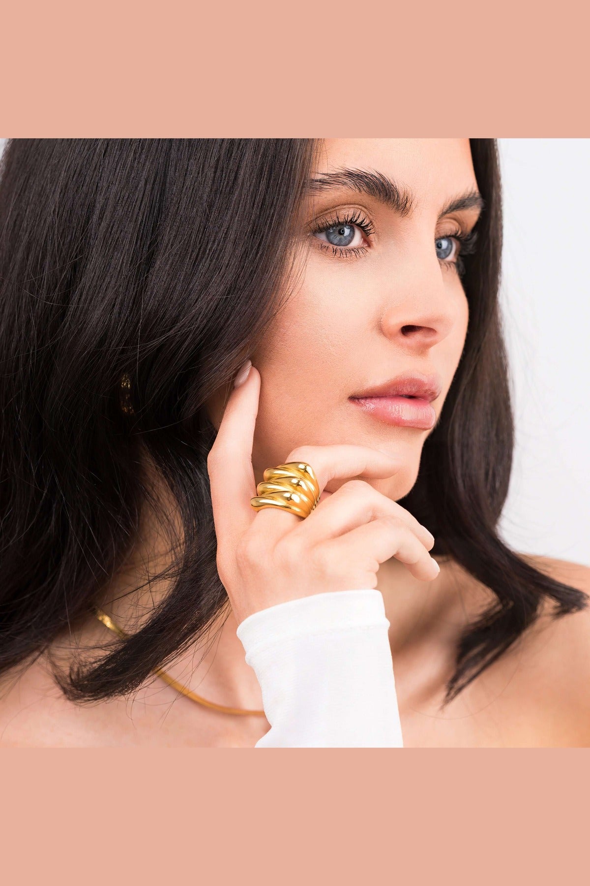 Model showcasing the Alina Gold Sculpted Statement Ring, featuring smooth ridges and a bold, elegant design.