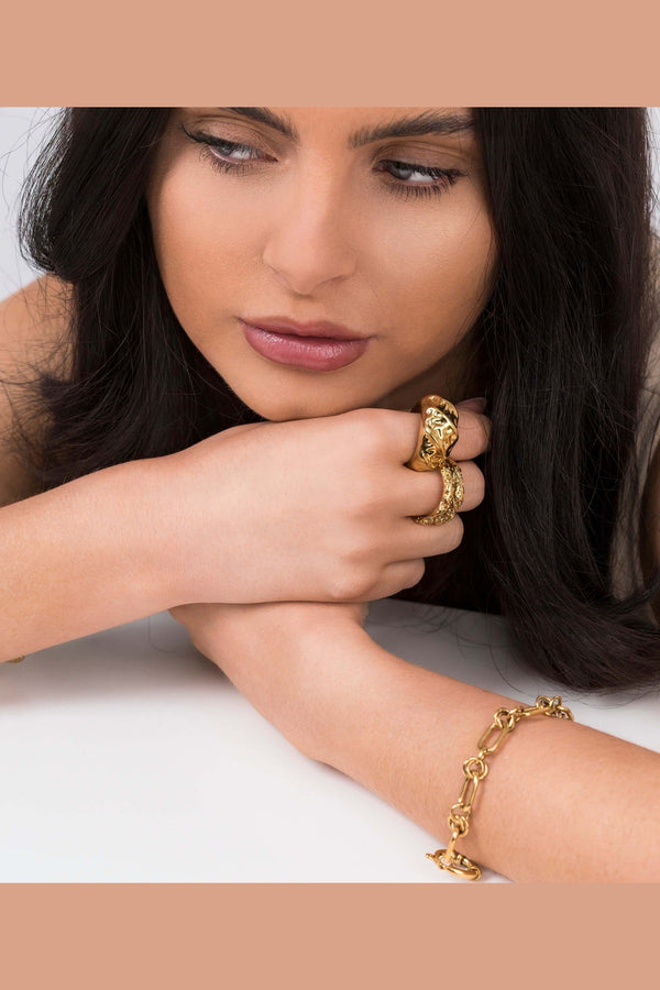 Woman wearing Mira Organic Texture Bold Ring by ARIIRA, showcasing its unique high-shine finish and sculptural design.