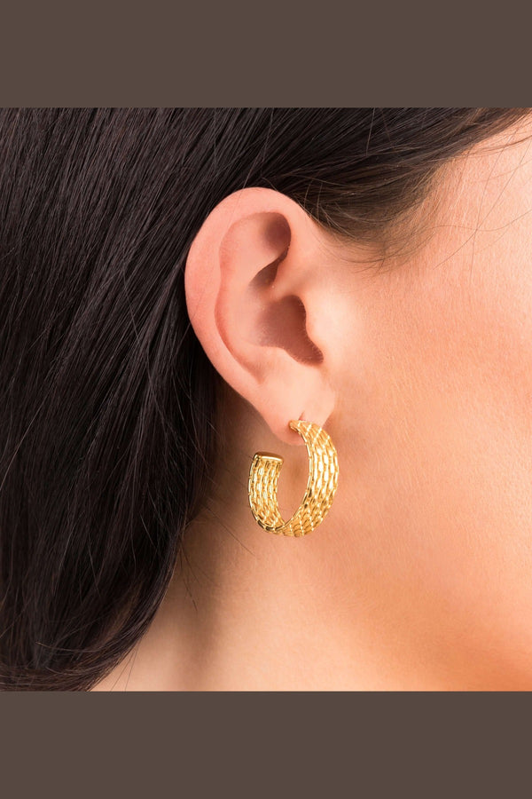 Lyra Gold Textured Hoop Earrings worn on ear, showcasing intricate woven design and modern elegance by ARIIRA.