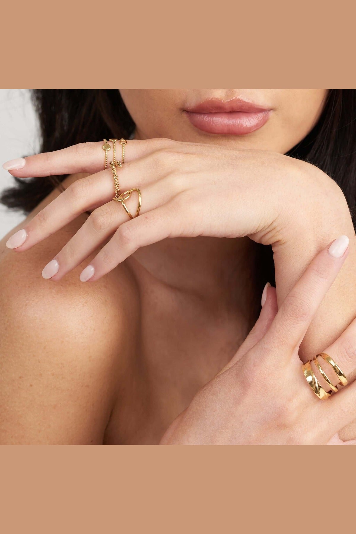 Close-up of Liana Triple Curve Ring worn on hand, showcasing elegant design and gold finish.