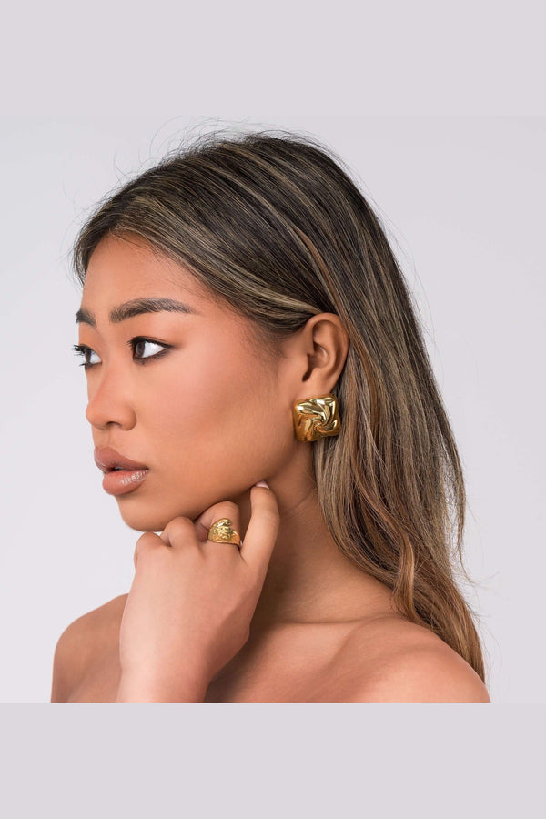 Mira sculpted stud earrings by ARIIRA, featuring gentle swirls and a lightweight, tarnish-free design, perfect for any style.