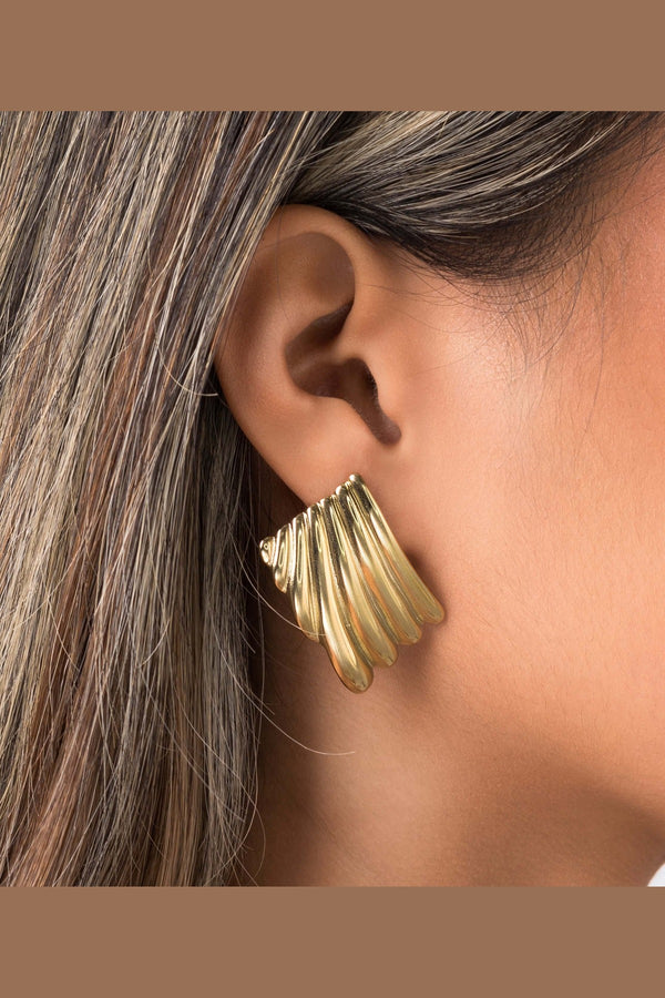 Gold Freya Sculpted Wave Hoops by ARIIRA, showcasing rhythmic ridged design in elegant silhouette.