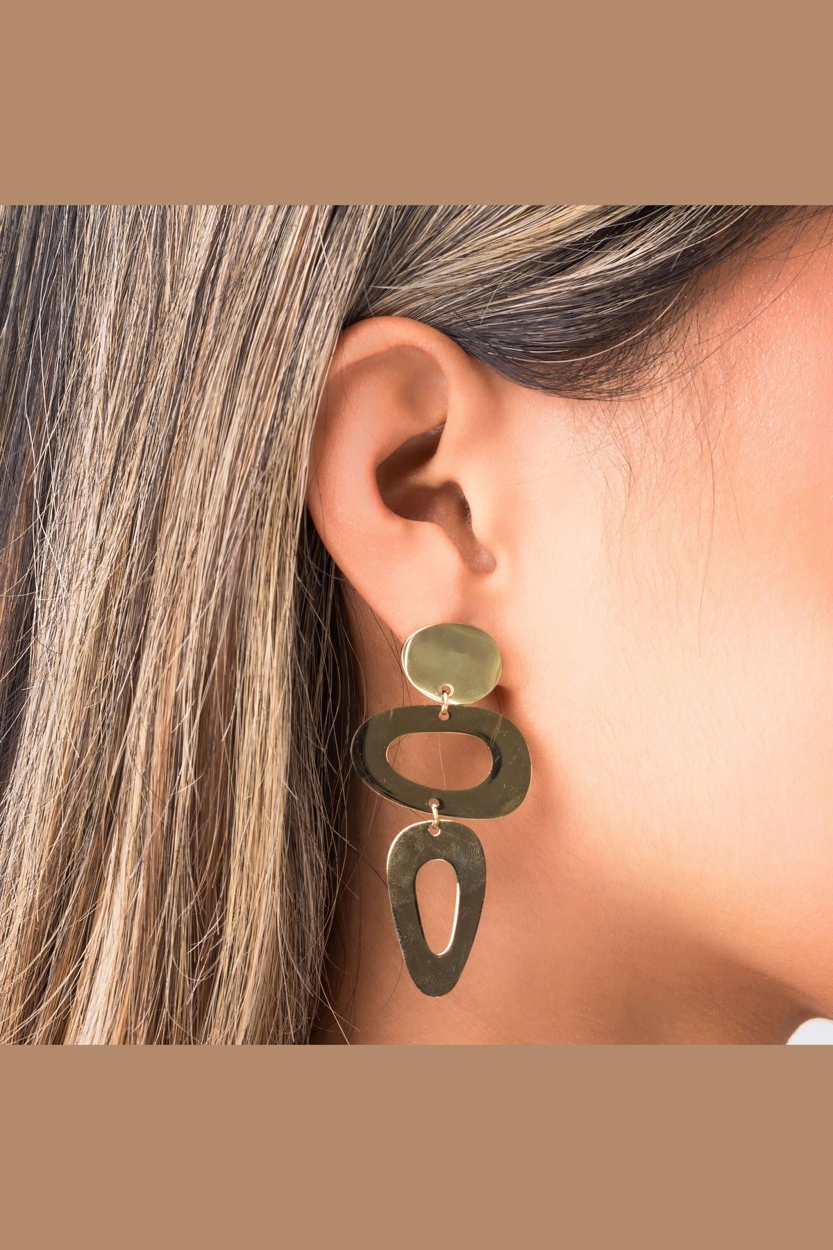 Iris Sculptural Drop Earrings by ARIIRA featuring dynamic shapes and a modern design, showcasing elegance and fluidity.